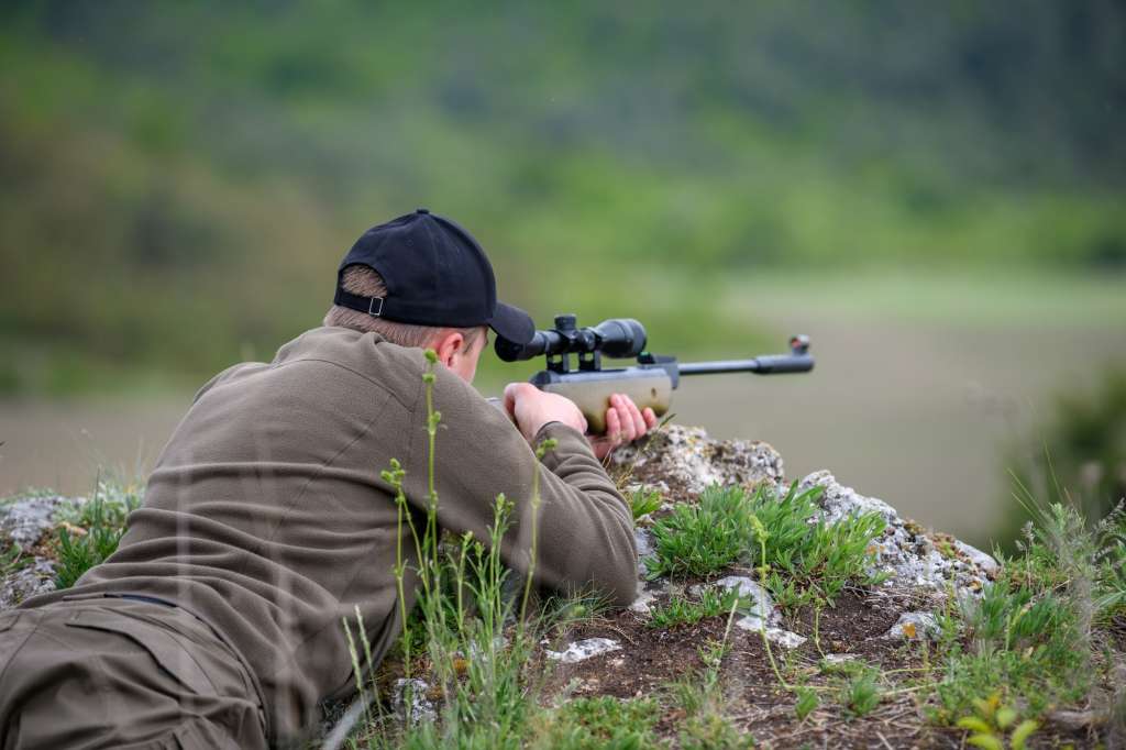 Male with a gun in hunting period